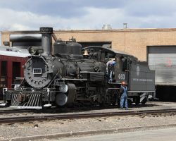 463 simmers in Antonito on the Sunday evening before the trip. Meanwhile, two tracks over, the shop crews are finishing fitting a spark arrestor to 487.