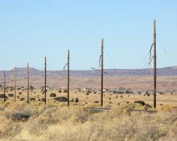 Between the mine and Cow Springs, this was a common sight. When the lines were cut, the tensioning weights weren't removed first. Consequently, the line recoiled with significant force, breaking supports, insulators, and sometimes entire poles.