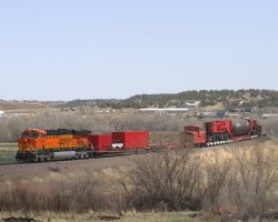 A couple miles down the line, the load passes over the bridge on the north side of Trinidad, CO, spanning the ex-Santa Fe Raton mainline.