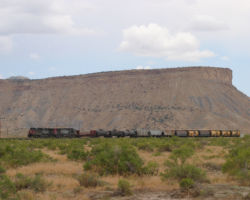 Now under threatening skies, SP 173 and 113 fly across the desert at Thompson