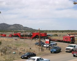 I assumed the load was headed up to Denver via Pueblo and Walsenburg, but that notion was quickly dispelled by a local BNSF employee. They were going to back the move onto the Raton line and get to Pueblo via La Junta in order to avoid clearance problems on the Trinidad-Pueblo direct route. Lots of people are gathered around to watch the move.