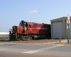 56 leads today's Springdale-Van Buren passenger train, seen here peeking out from behind the car barn at Springdale