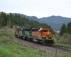 A rainy Monday morning greets BNSF 7155 east on Mullan Pass, just out of Austin, MT.