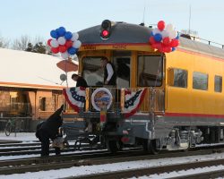 After pulling up a bit from the original stop, they again put down the stepstool for those returning to the train. Note the balloons that were added. The train stopped for a while at North Colorado Springs, so my guess is part of that was to add the balloons and fix the flag-like things on each side.