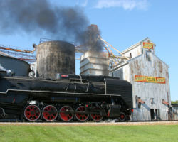 Chinese steam running past a typical old midwestern elevator with Kent Feeds signs on it - who would have ever thought this picture would happen?