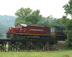 A few miles further, a light rain falls as 44 crosses a low trestle near Mountainburg, AR