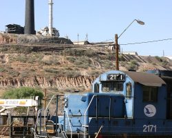AZER 2171 sits beneath the BHP mine and smelter that give it business at Miami. 2171 is ex-SP 4148, ex-SSW 808 and 4038, and had its nose chopped in 1993.