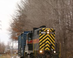 IAIS 468 and a single boxcar cross 42nd Avenue in Rock Island