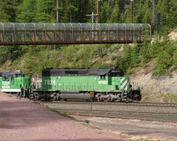 BNSF 7824 west at Essex, with the IWI's new pedestrian bridge above it.