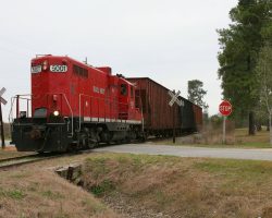 Having no particular desire to go shoot the returning turns on the Thomasville line (particularly with the ugly HALX units now in the lead), I headed down the line to Sparks and Adel. Just on the northwest side of Moultrie, I found one of the road trains interchanging with this local at Schley Junction. Here's the local, headed by GFRR 5001, headed back for downtown Moultrie.
