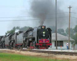 Passing through Sheffield, with the old, boarded-up depot behind the train.