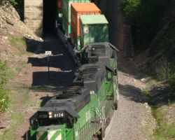 The three FURX SD40-2s emerge from Tunnel 3.8 with the westbound