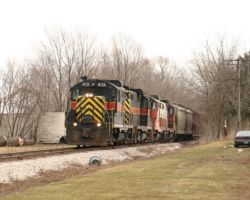 Emerging from the trees, BICB-24 crests the grade.