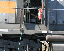 The lease unit is apparently low on coolant, as there's a hose running into the engine compartment and water is running out the bottom. Seems to be more than full...