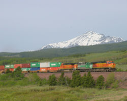 BNSF 4746 descends the grade eastward with the Continental Divide in the background.