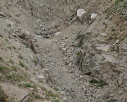 The top stones are now all that's visible at the western portal of the Alpine Tunnel. Originally, a snowshed extended through this curved cut. At the end were doors that would be shut when not in use, in an effort to keep snow and ice out of the tunnel itself.
