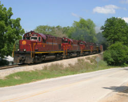 At Garfield, AR, 68 and train round the curve and blast the horns for the Hwy 127 crossing.