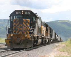 The three units finish their push as the majority of the train crests the grade