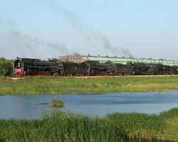 Stopped in Silvis to let off passengers, with some great evening light and some sort of catch basin in the foreground. The big building in the background is part of the famous Silvis Shops of the Rock Island Railroad. Today it's NRE's Silvis facility, formerly Chrome Crankshaft.