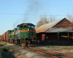 Passing the old station in Morven, long ago converted for other uses. The train wouldn't make the next town - Quitman - in daylight, due to only having a single working unit.