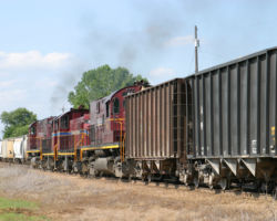 The four motors drag a cut of sand cars north towards the yard.