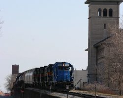 In the shadow of the Scott County Courthouse and Jail, the crew is almost ready to leave with BICB-27. In the lead is leaser LLPX 2042, followed by IAIS 602, 401, 468, and 407.
