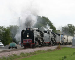 After the RiverWay 2006 excursions, the two QJs worked their way west at the point of a 20ish car freight on Monday morning. Here they are crossing Y-40 at Walcott, IA. (DJH Photo)
