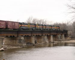 The six black units pulling BICB-29 cross the Cedar River at Moscow, IA. They are, in order from front: 625, 603, 601, 600, 627, and 402.