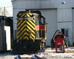 Back to Iowa Interstate, 402 sits in the sunlight outside the Council Bluffs, IA, shops on 20-Dec-2003.