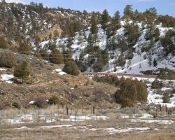 The next stop east is Monero, and on the way one can clearly see the right of way cut into the hillside on the left.
