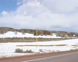 Between Biggs and Chama, the line crosses the Continental Divide on a rather non-descript hump in the ground. However, the old grade can still be seen north of the highway in many places.