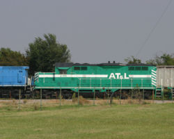 Just south of Watonga, OK, we find more colorful AT&L road power, in this case ATLT 2165, an ex-ATSF GP7u.
