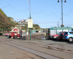 The north end of the Douglas Horse Tram, known as Strathallan, and the south end of the Manx Electric, known as Derby Castle.  The two lines, despite being the same gauge, do not interconnect.
It appears the Horse Tram has left some, um, "exhaust" on the tracks to the right.