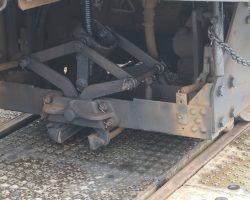 At the other end of the truck from the guide wheels is a screw-driven clamp with brake shoes. When applied, these shoes grip the sides of the Fell rail and slow the car (or prevent it from moving at all)