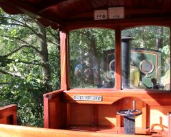 Inside one of the beautiful hardwood coaches on the short trip over the line. These are authentic recreations of the line's original cars. If you're wondering, the wheel is the handbrake.