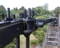 From about halfway up the tower, this is looking at the first knuckle in the power transmission shaft. This first one rides on a giant arm, unlike the rest that sit on small rail wheels.