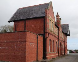 It being a generally nice day once you got away from the winds of the coast, I decided I'd hike up to the next stop rather than boarding the train at Port Erin. The next stop east on the line is Port St. Mary. This elaborate brick station was built around 1900. The station building itself is still owned by the railway, but apparently empty.