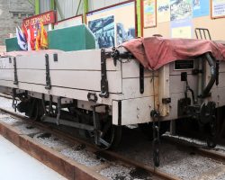 This is "two plank" (referring to the side height) side dump car M.78, built in 1925. They were intended for ballast service, but were often found hauling freight due to their versatility.