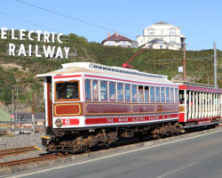 #6 and trailer under the famous "Electric Railway" sign with the shops complex in the background.