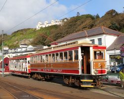 At Derby Castle, the south end of the Manx Electric shares a terminal with the north end of the Douglas Bay Horse Tram (who calls the location Strathallan). Here's car 5 with a roofed toastrack trailer attached getting ready to head north.