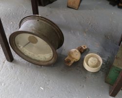 The big meter on the left is a Mather & Platt ammeter, and given its range from 0-160A, I'm guessing it was for measuring trolley line current draw. The ball in the middle is part of the trolley wire hanger system. The thing on the right looks like a battery rest insulator.
