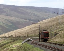 A pretty typical view along the line as it snakes up the southern side of the Laxey River valley. This was taken looking out the back window of my tram headed up at about the halfway point. The small building below the track is the line's original powerhouse, now disused.