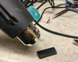 Apply low heat to the assembly to tighten up the heat shrink.