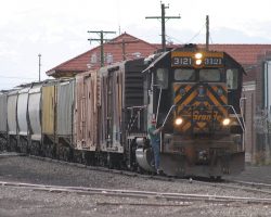 As 3121's nose light plate has taught for years, "Hard work will set you free." Seen here passing the Alamosa depot on the tail of 3128's train, it has a little more work in the yard to do.