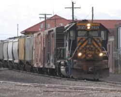 As 3121's nose light plate has taught for years, "Hard work will set you free." Seen here passing the Alamosa depot on the tail of 3128's train, it has a little more work in the yard to do.