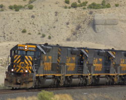 Friday's returning Dirt Train with a string of empties, speeding along through the Utah desert.