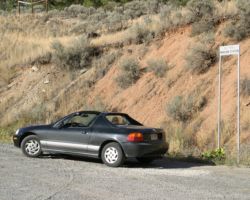 My wimpy little convertable, parked under the BC Rail Pavilion Station sign.