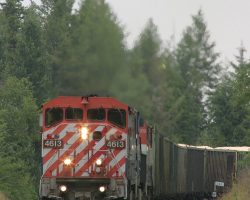 4613 comes roaring around the corner at MP 361... in the pouring rain.