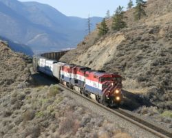 Passing through a cut and over a fill, high above the Fraser near Gibbs.