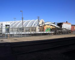 Having been moved from the former Burnham Shops site, D&RGW derrick 029 and its associated flat wait inside the Forney Museum's fence.